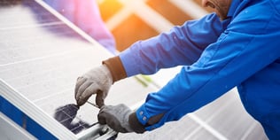 technician installing solar panels