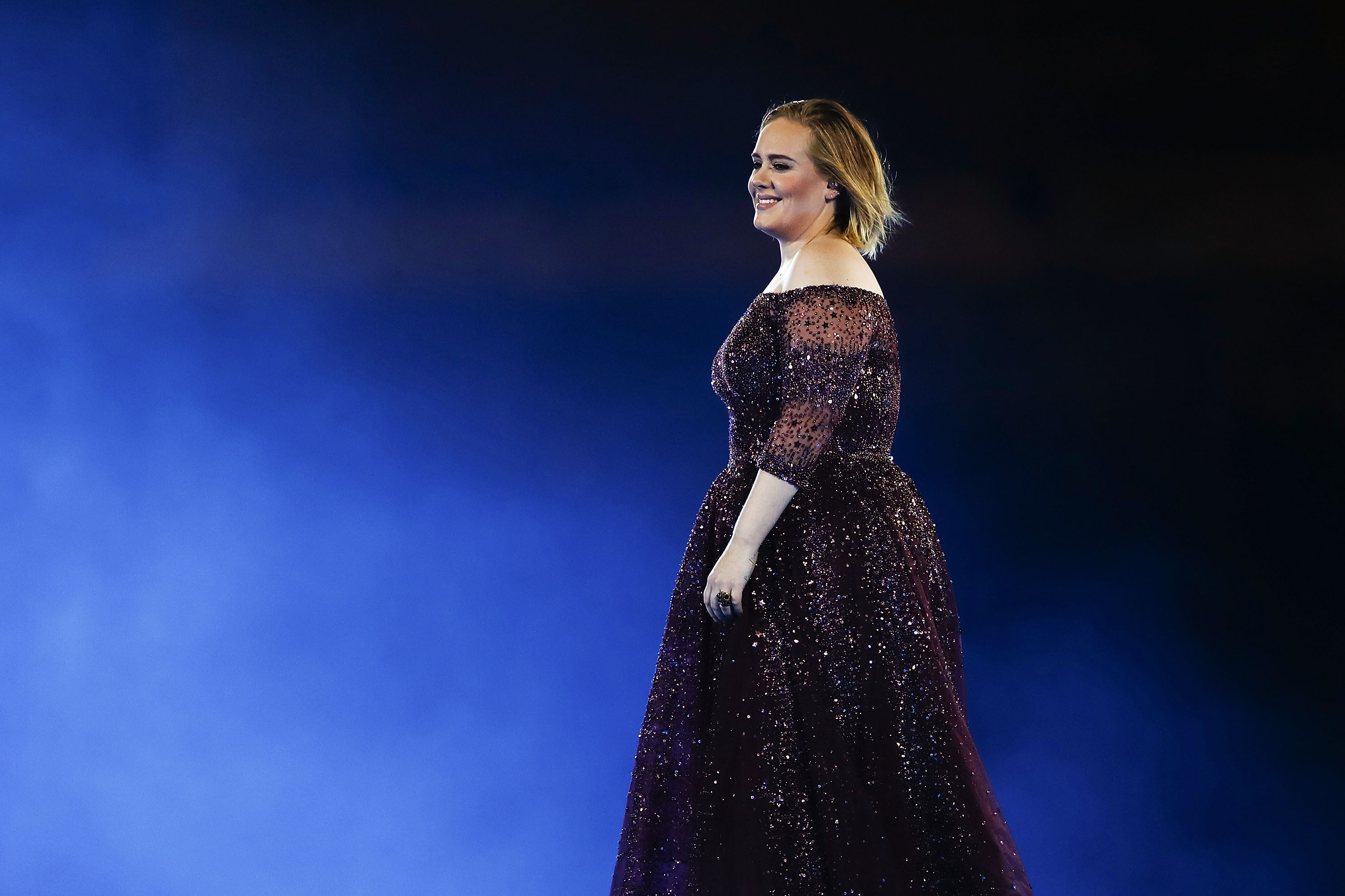 Adele live in concert in gown 